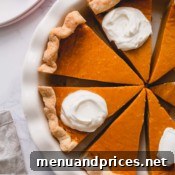 Velvet Pumpkin Dream Pie 7 Overhead shot of sliced pumpkin pie in a pie dish.