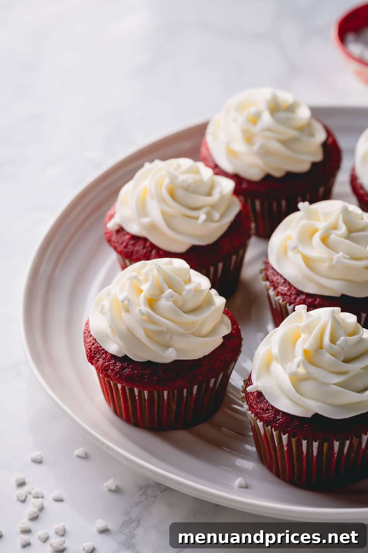 Velvet Dream Cupcakes 8 A close-up shot of a platter of red velvet cupcakes with elegant cream cheese frosting swirls, ready to be served.
