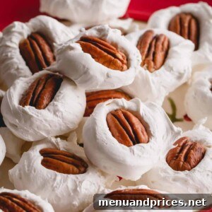Grandma's Divinity Sweet 11 A pile of divinity with pecan halves on top on a red plate.