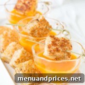Small circular image of a bowl of butternut squash soup with a spoon, highlighting its creamy texture.