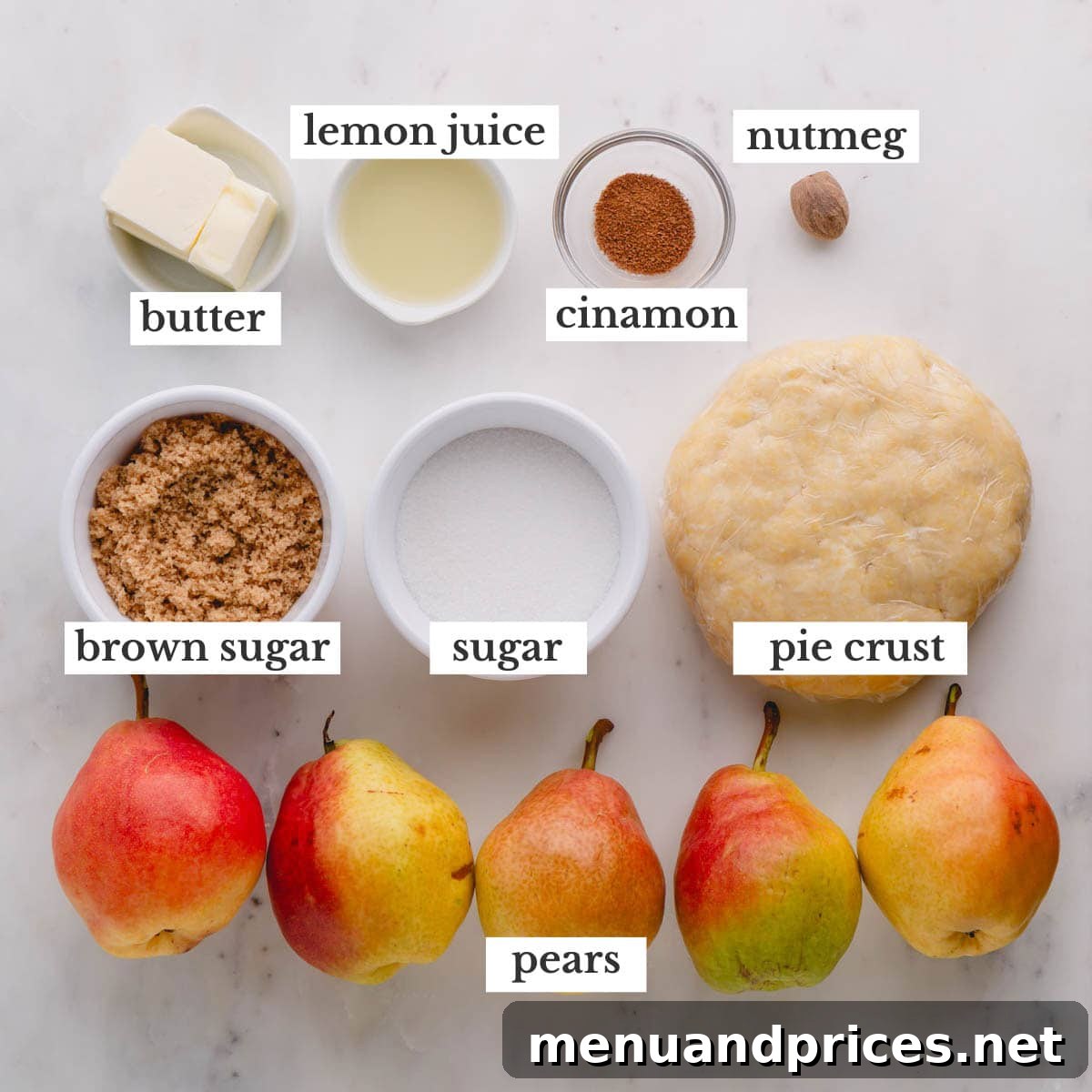 All the essential ingredients neatly arranged on a counter, ready to make pear tarte tatin.
