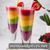 Two tall glasses of rainbow smoothies, perfectly layered.