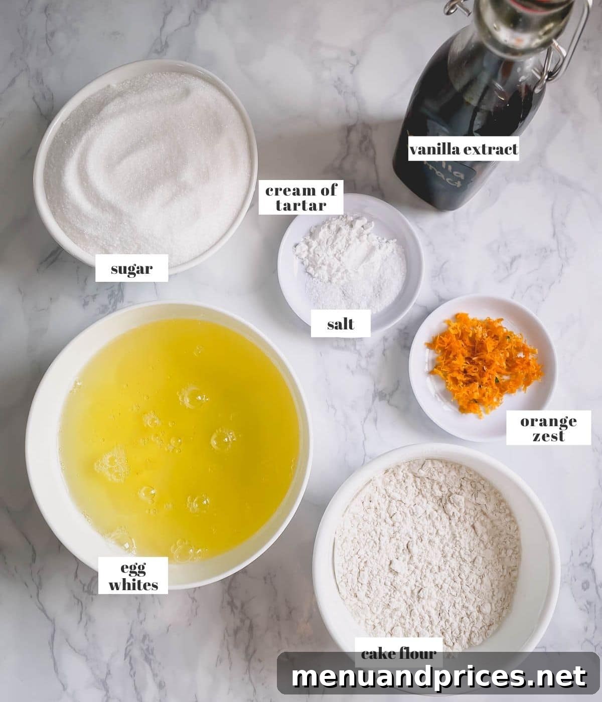 Light & Airy Angel Food Delight 3 Carefully laid out ingredients for Angel Food Cake: egg whites, cake flour, caster sugar, orange zest, cream of tartar, vanilla extract, and salt.