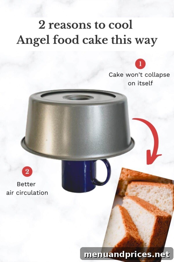 Light & Airy Angel Food Delight 8 An Angel Food Cake cooling upside down on a tube pan, balanced on an inverted mug to maintain its airy structure.