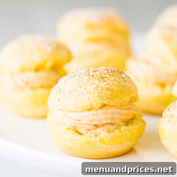 Pumpkin Spice Cream Puffs 2 Light and airy pumpkin cream puffs with a smooth, dreamy pumpkin filling, ready to be enjoyed as a perfect fall dessert.