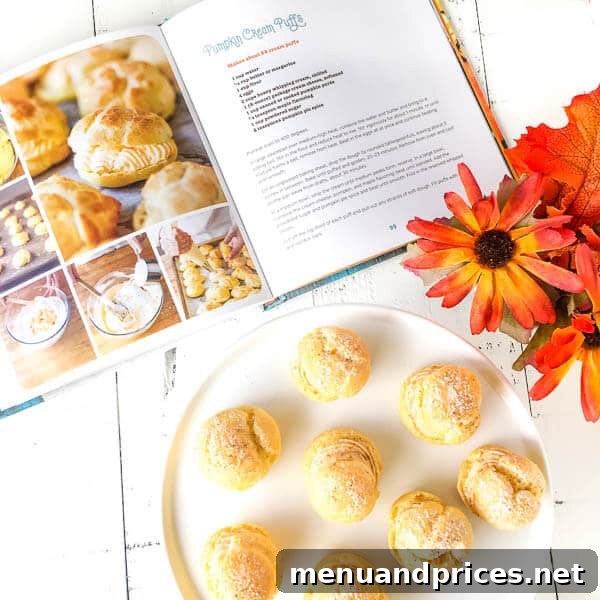 Pumpkin Spice Cream Puffs 3 A selection of freshly baked pumpkin cream puffs, showcasing their golden choux pastry shells and inviting appearance.