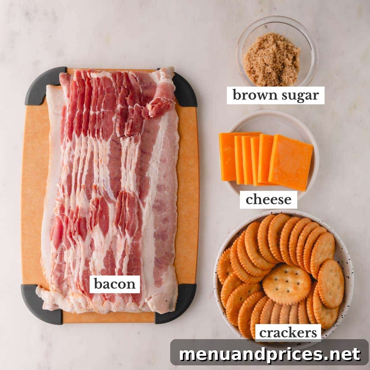 Bacon Cheddar Crisps 4 A clear flat lay photo displaying the four main ingredients: thin bacon strips, square slices of cheddar cheese, Ritz crackers, and a small ceramic bowl filled with brown sugar.