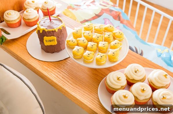 Celebrating Grant's First Trip Around the Sun 4 Winnie the Pooh shaped macarons and vanilla cupcakes