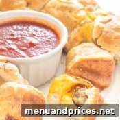 Close-up of baked Meatball Stuffed Monkey Bread with marinara sauce.