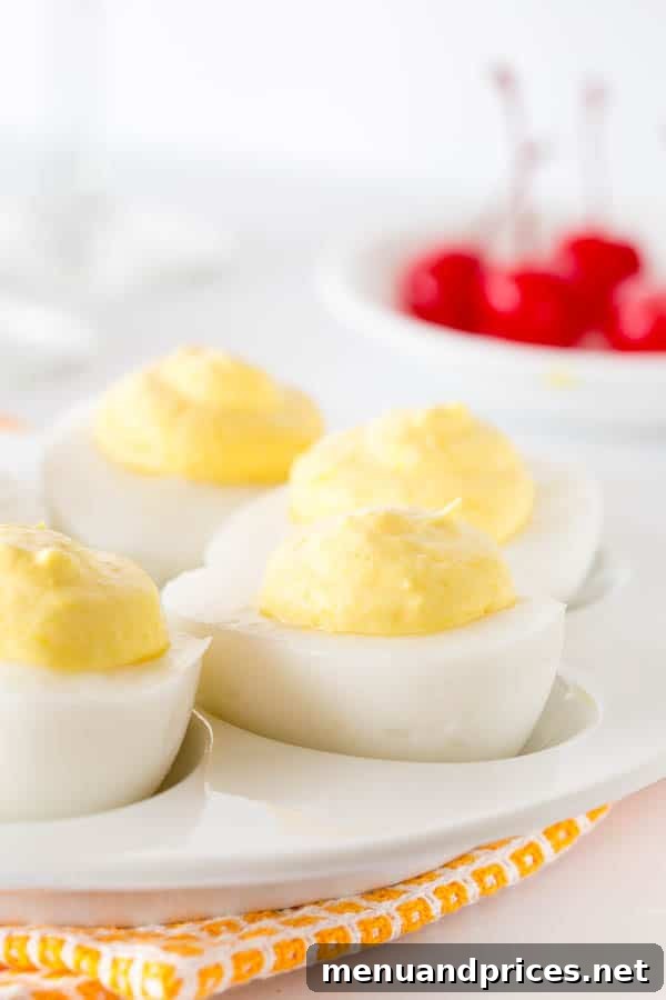 Tropical Pina Colada Deviled Eggs 2 Realistic-looking deviled eggs on a serving platter, revealing a sweet, tropical surprise upon closer inspection.