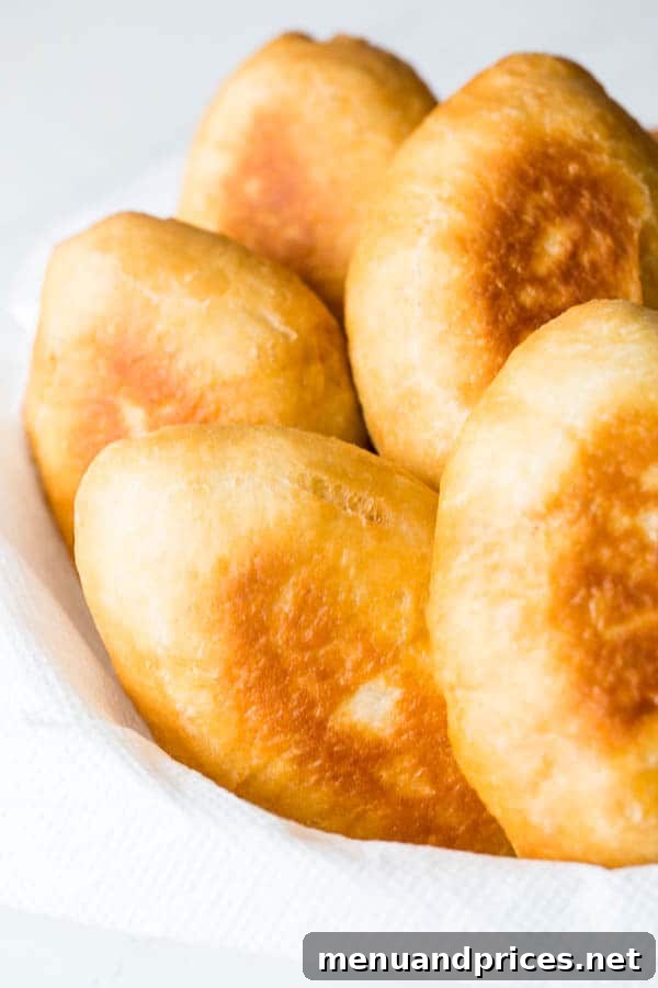 Hearty Russian Meat Piroshki 2 The softest and fluffiest Russian piroshki (hand pies) with a simple beef and rice filling, a secret family recipe.