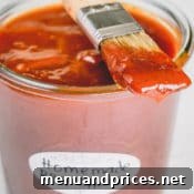 A jar of homemade BBQ sauce with a brush, footer image.