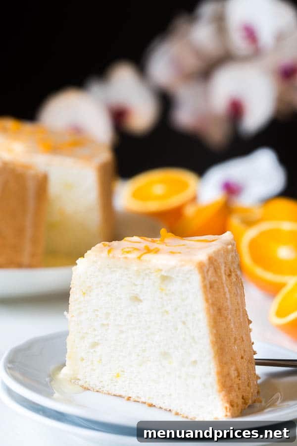 Dreamy angel food cake, incredibly light and fluffy, infused with citrusy floral orange blossom, topped with sweet and tangy orange curd.