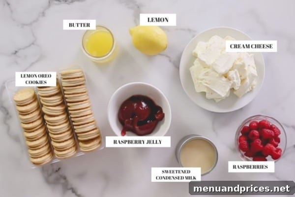 Zesty Berry No-Bake Cheesecake Bliss 4 A collection of fresh, high-quality ingredients laid out on a clean surface, including lemon Oreo cookies, unsalted butter, cream cheese, sweetened condensed milk, fresh lemons, and a jar of seedless raspberry jelly, ready for cheesecake preparation.