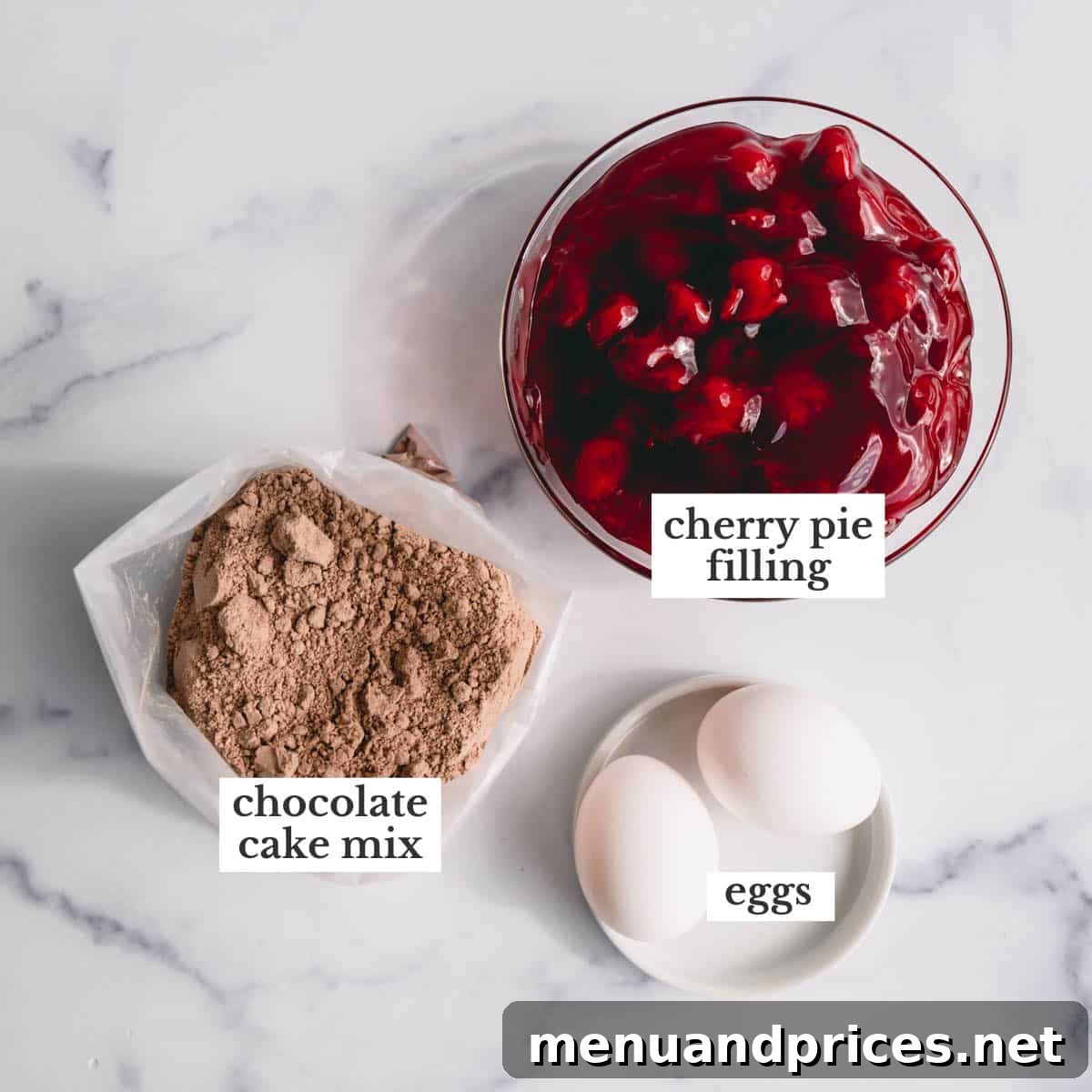 Effortless Chocolate Cherry Bliss 3 A visual display of the three simple ingredients required for this delicious chocolate cherry cake: eggs, a box of Devil's food cake mix, and a can of cherry pie filling.