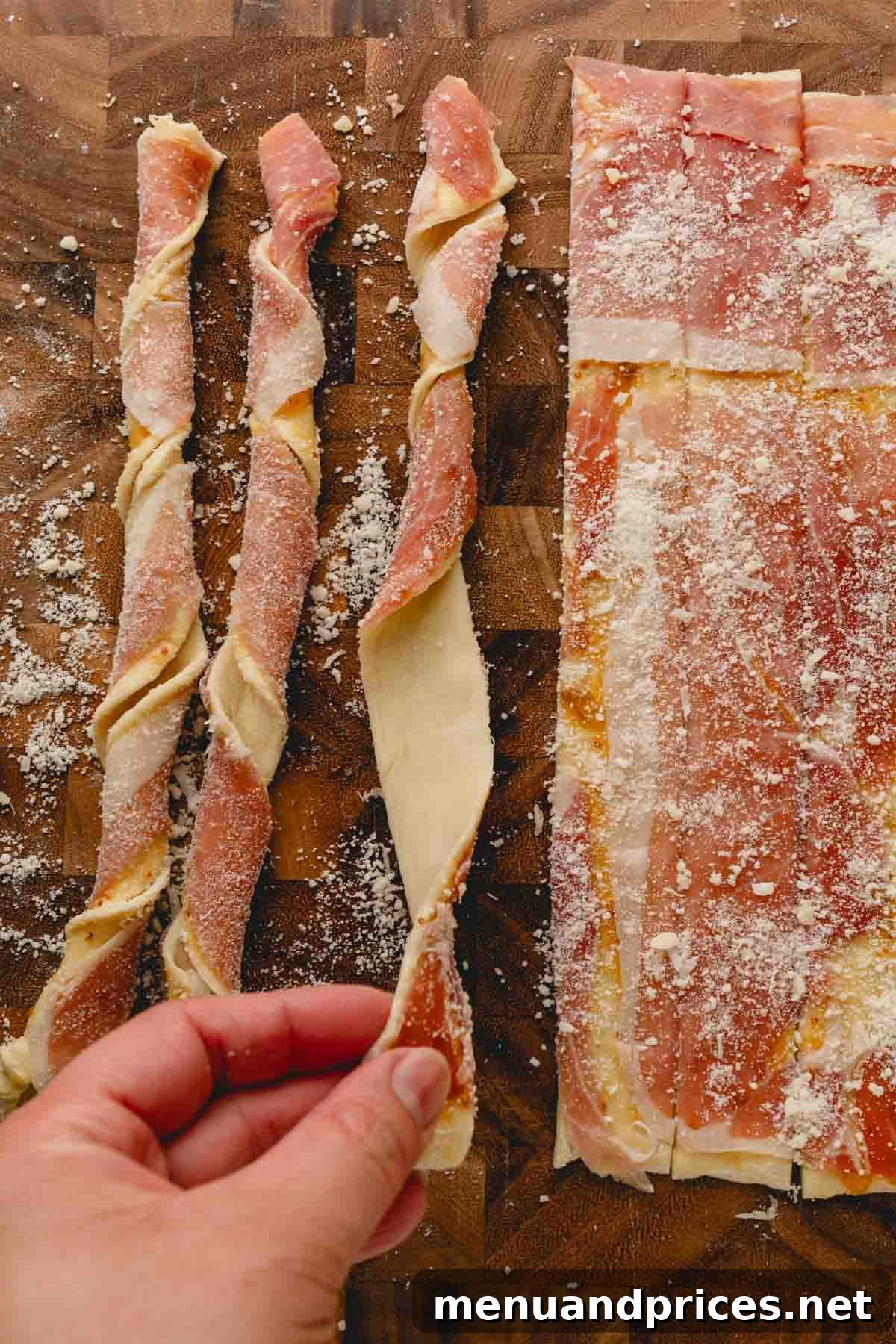 Golden Savory Spirals 7 Twisting the puff pastry strips with prosciutto side out.