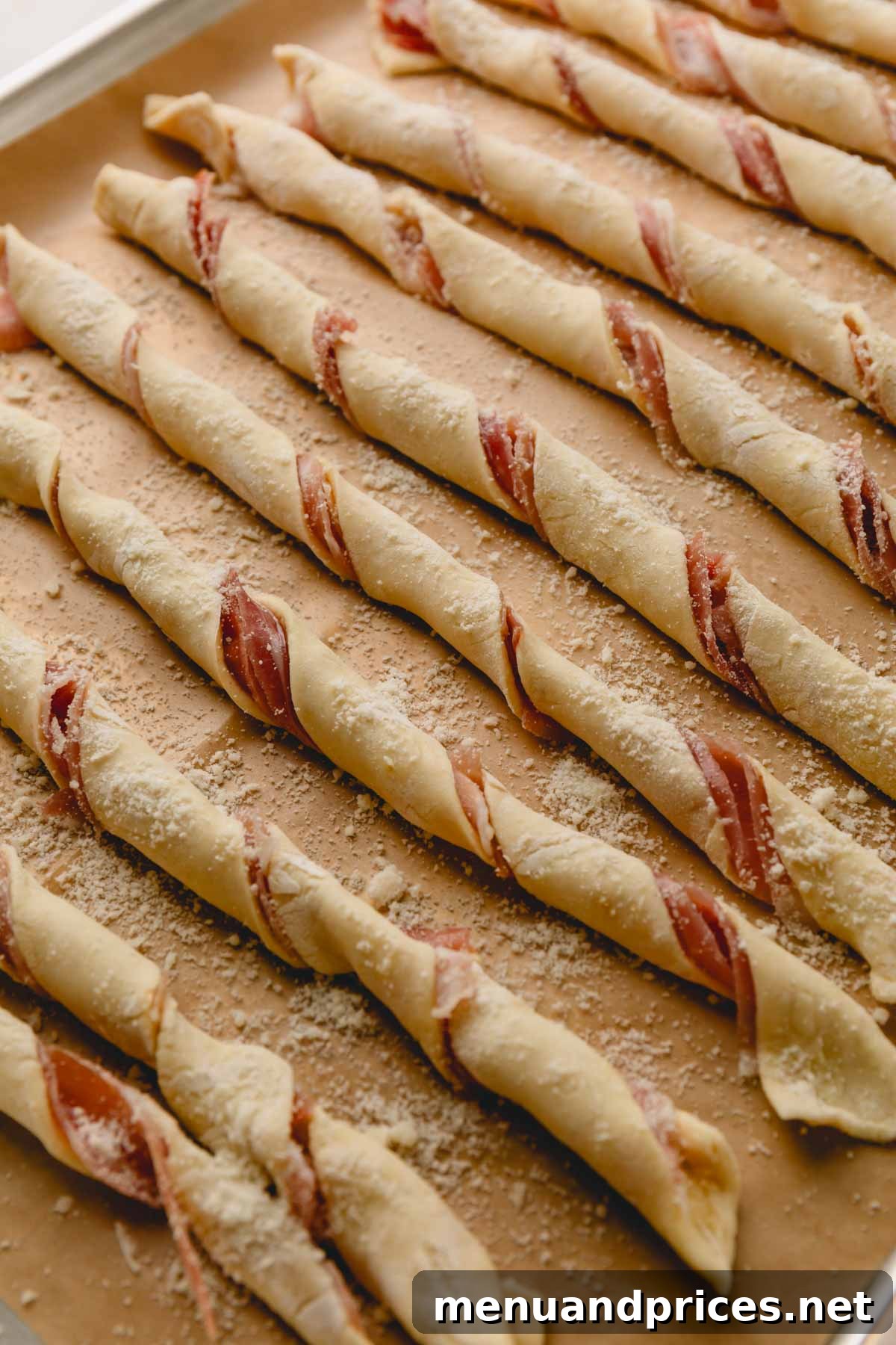 Golden Savory Spirals 8 Twisted the puff pastry strips with prosciutto side on the inside arranged on a baking sheet.