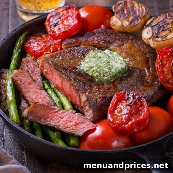 A stunning pan-seared ribeye steak, perfectly sliced and topped with generous portions of aromatic herb butter, served with fresh greens, highlighting a truly impressive meal.