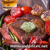 A beautifully cooked pan-seared ribeye steak, ready to be enjoyed.