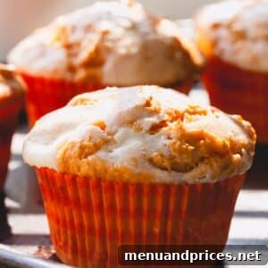 Pumpkin cheesecake muffins in muffin liners.