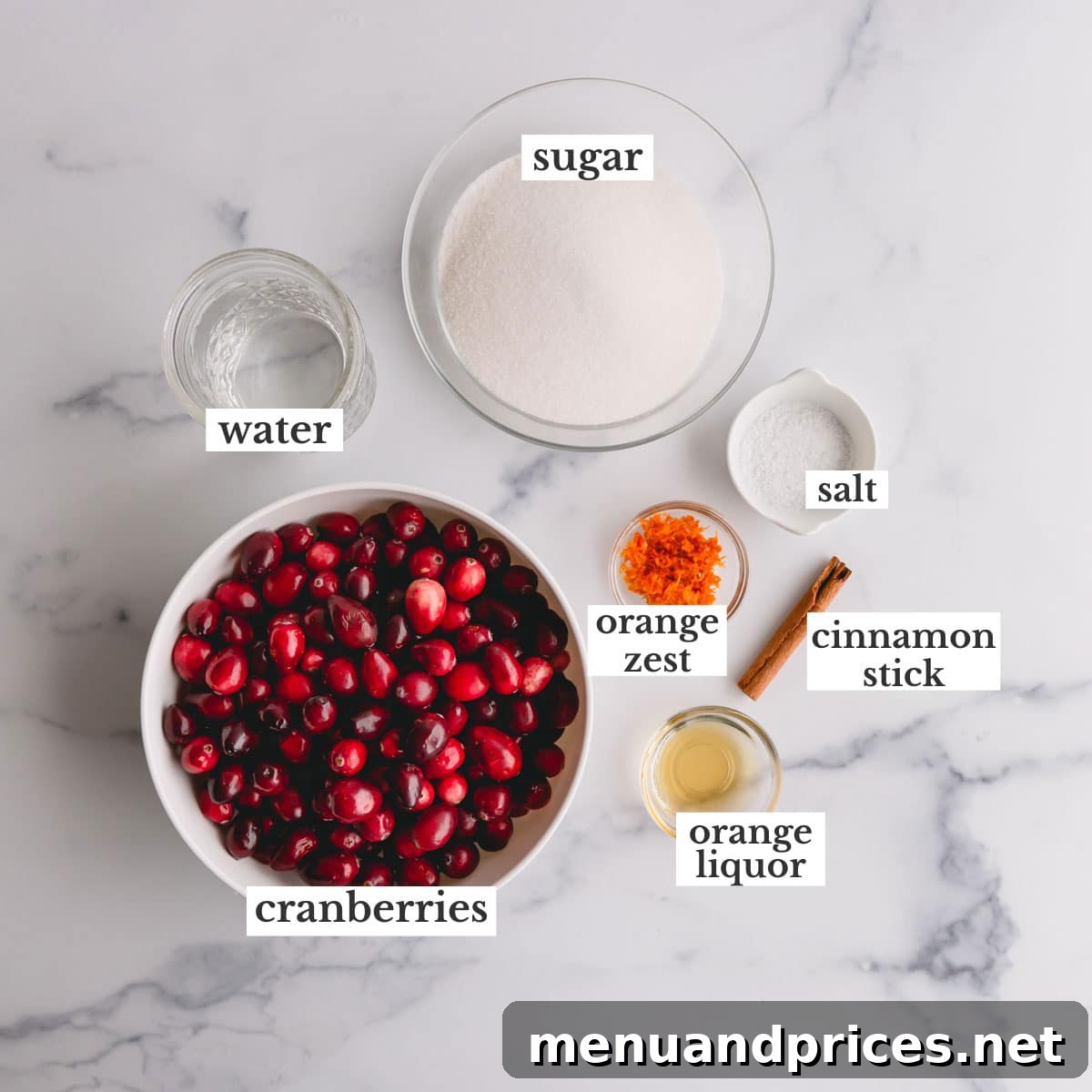 Zesty Orange Cranberry Sauce 4 All the fresh ingredients for making homemade cranberry sauce laid out on a clean counter: cranberries, sugar, orange, cinnamon stick, and water.