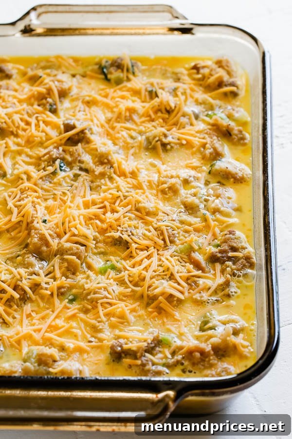 Post-Feast Stuffing Breakfast Bake 5 An unbaked cheesy leftover stuffing breakfast casserole, with the egg and cheese mixture poured over the stuffing, ready for the oven.