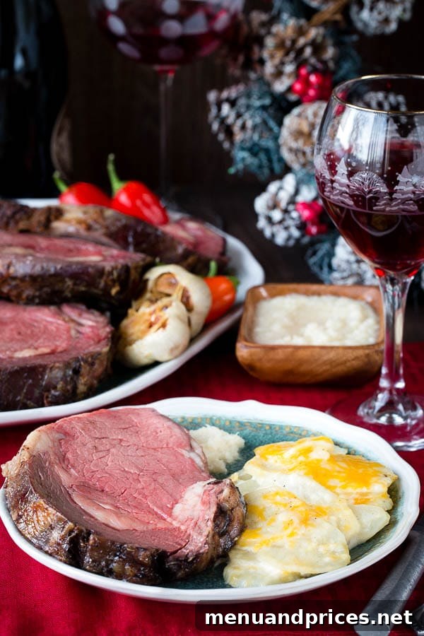 Signature Garlic Herb Crusted Boneless Prime Rib 6 A delectable plate of garlic herb crusted prime rib, accompanied by creamy mashed potatoes, ready to be enjoyed.
