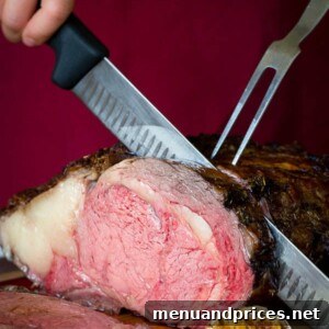 Garlic herb crusted prime rib being sliced.