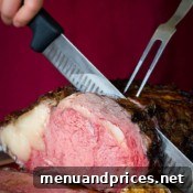 Garlic herb crusted prime rib being sliced.