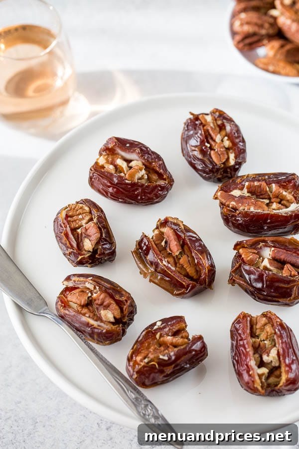 Warm Stuffed Date Delights 2 Roasted stuffed dates with cream cheese and nuts on a plate, garnished with fresh herbs.