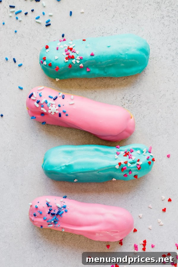 Two gender reveal eclairs, one with pink sprinkles and one with blue, showcasing a delightful way to announce a baby's gender. #GenderReveal #Eclairs #BabyAnnouncement