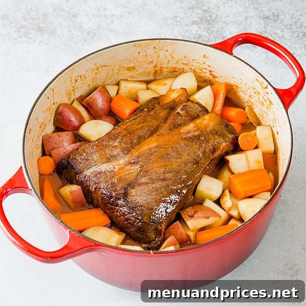 No-Fuss Pot Roast 5 Fresh root vegetables including large chunks of red potatoes and carrots, prepared and ready to be added to the Dutch oven for the pot roast.