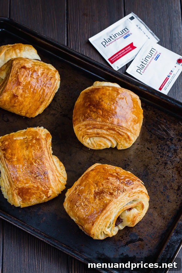 Final presentation of perfectly baked homemade Pain au Chocolat (chocolate croissants) from scratch, highlighting their flaky texture, rich chocolate filling, and appealing golden crust. A deeply rewarding result for any home baker.