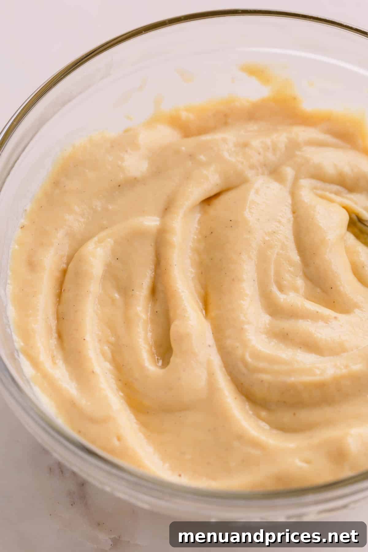 Luscious Banana Dream Pie 6 Homemade vanilla pudding, smooth and creamy, served in a clear glass bowl, ready for chilling.