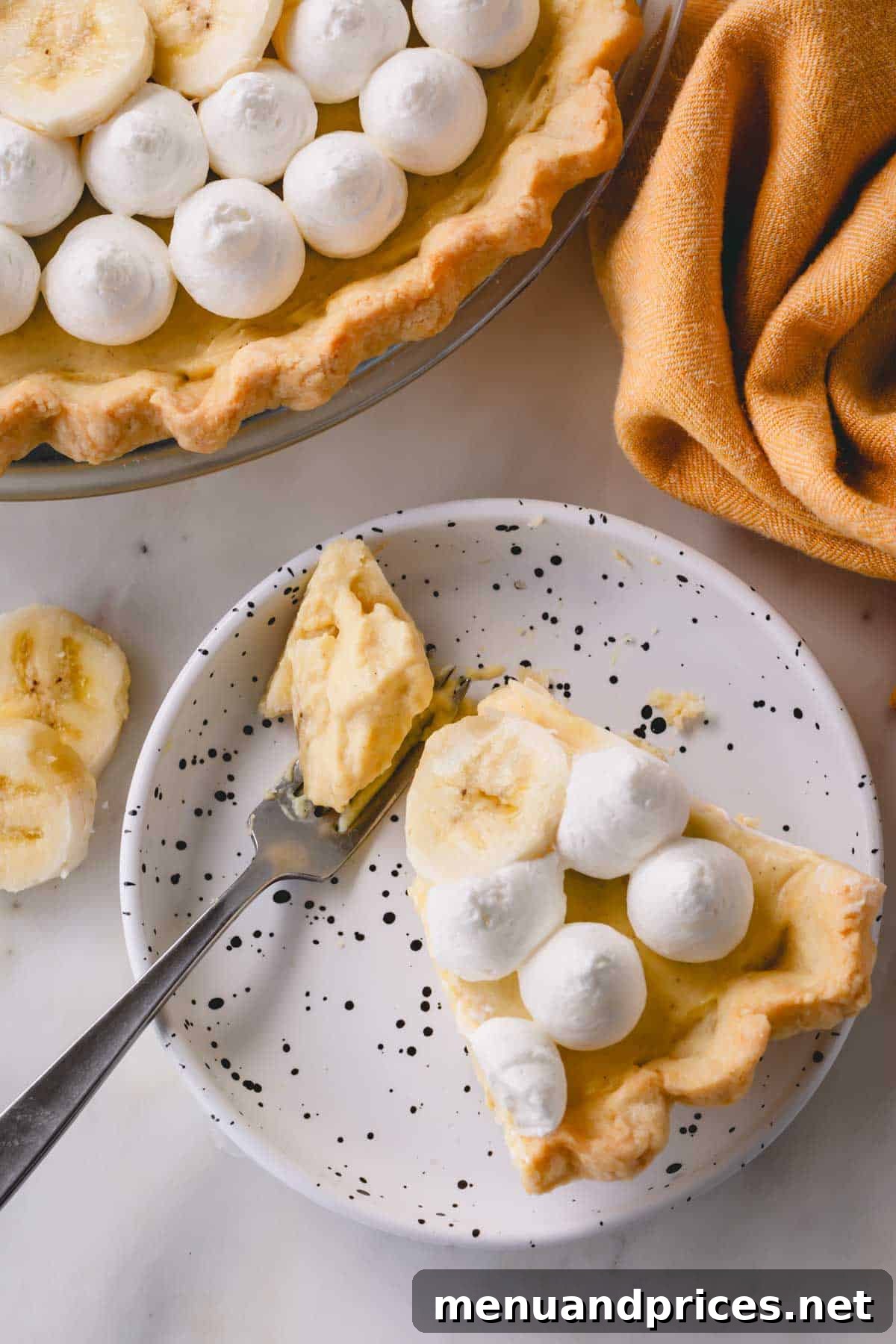 Luscious Banana Dream Pie 10 A perfectly portioned slice of banana cream pie on a delicate small plate, ready for a delectable tasting.