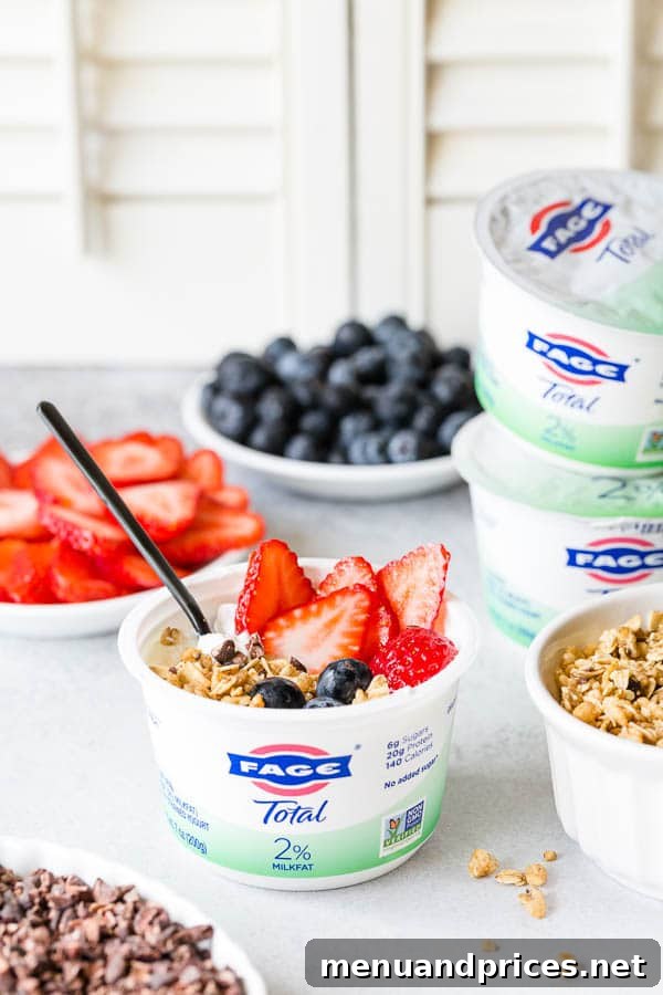Crafting Your Dream Yogurt Bar 5 A classic yogurt bowl adorned with fresh strawberries, blueberries, granola, and a sprinkle of cocoa nibs, making for an easy, fun, and delicious healthy breakfast or afternoon snack. #yogurtbar #snack #healthysnack #snacktime #yogurtbowl