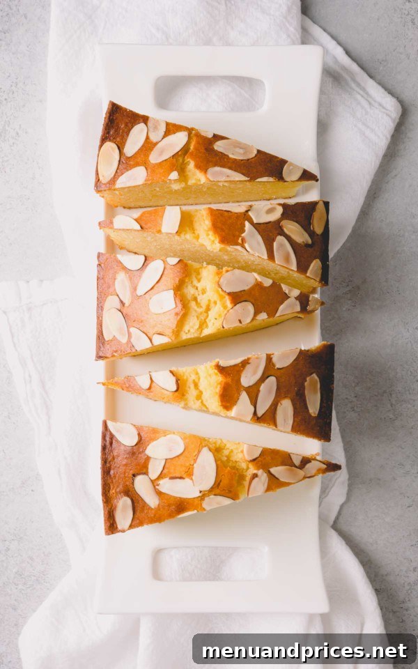 Yogurt-Kissed Almond Cake 2 A slice of almond yogurt cake on a plate, showing its moist crumb and delicate texture.