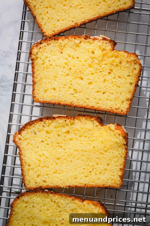 Yogurt-Kissed Almond Cake 7 A large slice of almond yogurt cake showcasing its perfectly golden brown crust and tender interior.