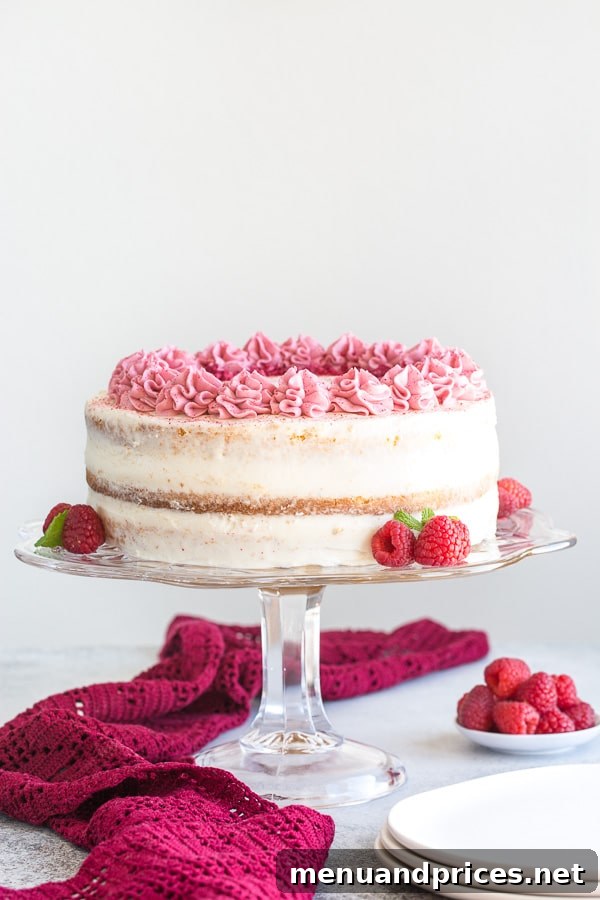 Tall and elegant raspberry cake with cream cheese frosting and visible jello layers, perfect for celebrations.