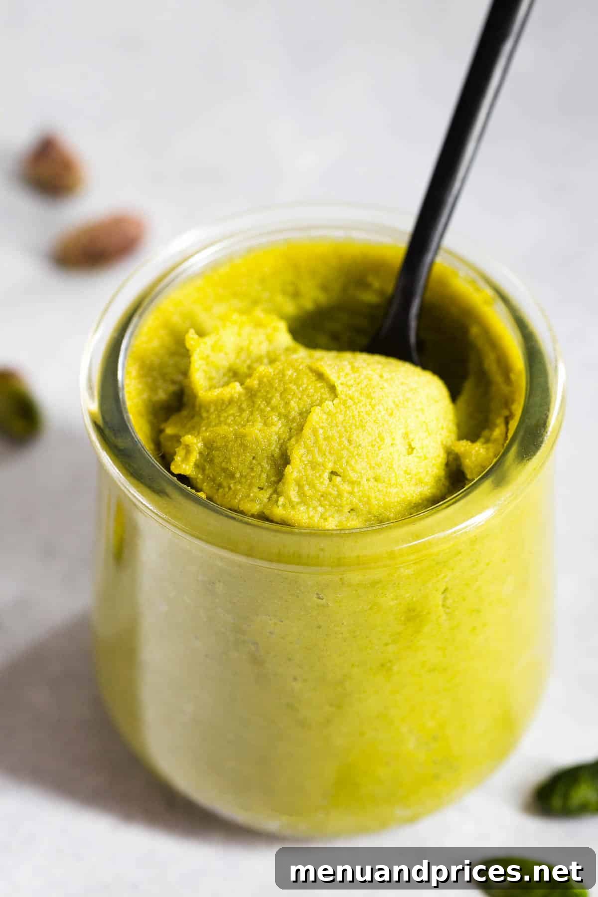 Easy Homemade Pistachio Paste Recipe 2 A glass jar of smooth, vibrant green homemade pistachio paste, ready to be used in various recipes.
