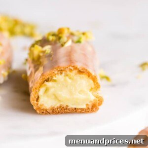Finished pistachio eclairs with white chocolate pistachio mousse filling.