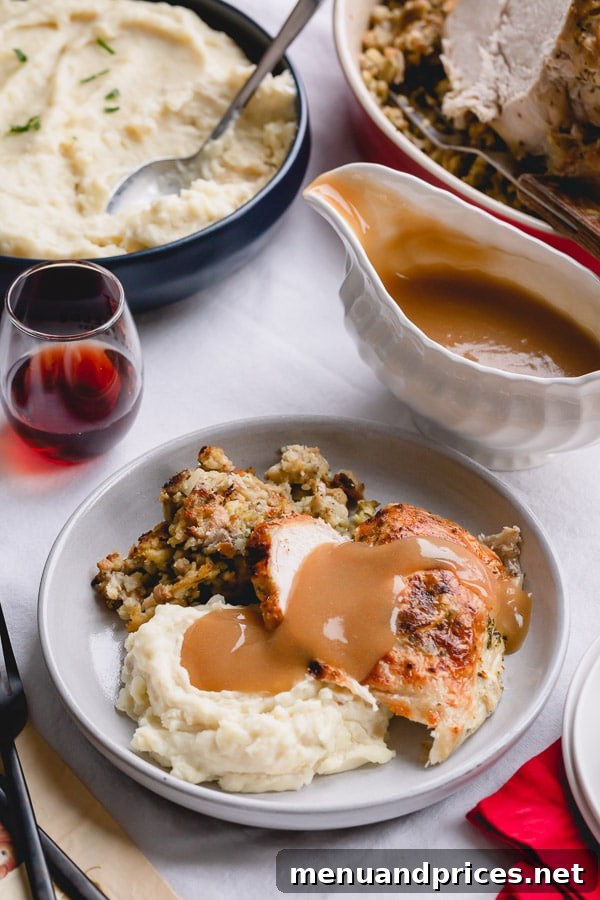 Juicy Instant Pot Turkey Breast with Homestyle Stuffing and Fluffy Mashed Potatoes 2 A plate of perfectly cooked Instant Pot turkey breast, alongside a generous portion of mashed potatoes and herbed stuffing, all drizzled with rich turkey gravy.