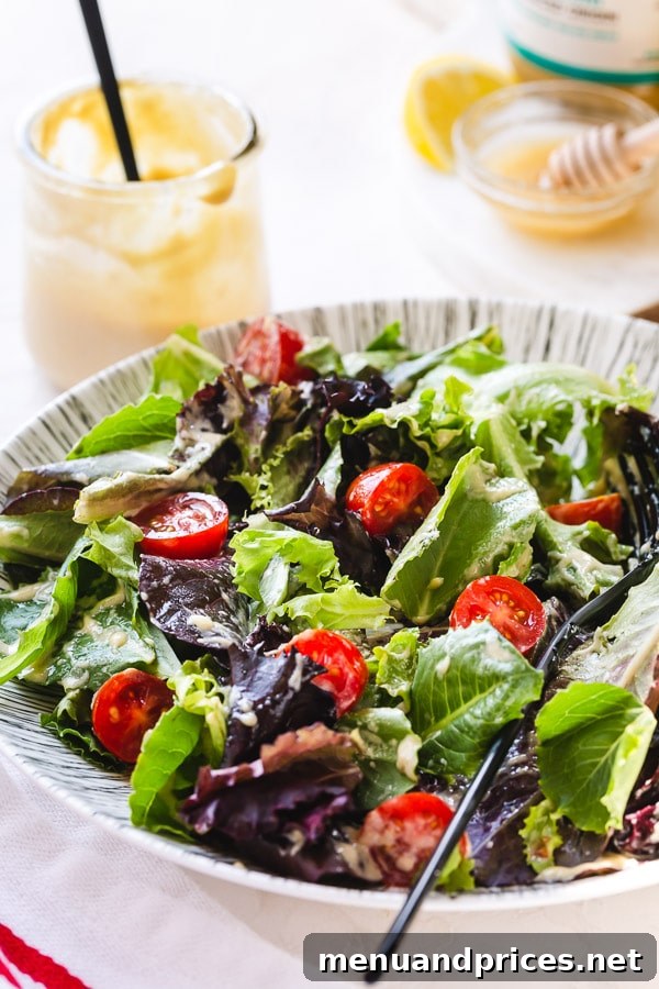 Tahini's Secret Weapon 4 Delicious green salad generously drizzled with rich and creamy tahini dressing, ready to be enjoyed.