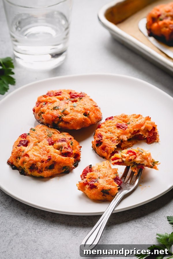 Baked Salmon Cakes are a delicious way to have a healthy but flavorful dinner. Baked, not fried, these perfectly portioned salmon cakes are packed with fresh salmon, roasted red pepper, fresh herbs and zesty Worcestershire sauce! #salmoncakes #salmon #seafood
