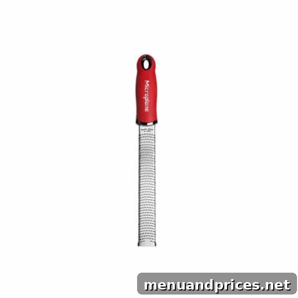A high-quality microplane zester, a must-have kitchen tool for finely grating ingredients like garlic, citrus zest, and spices.