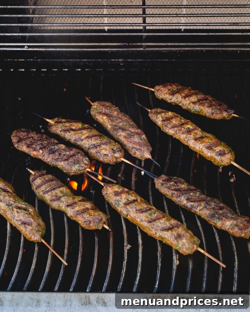 Urfa Kebabs: Mesopotamian Delights 6 Beautifully grilled Urfa kebabs on metal skewers, illustrating the perfect cooking and presentation.