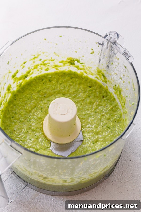 Vibrant Garlic Scapes Pesto from Scratch 4 A bowl of freshly made garlic scapes pesto served with pasta, demonstrating its versatility and deliciousness.