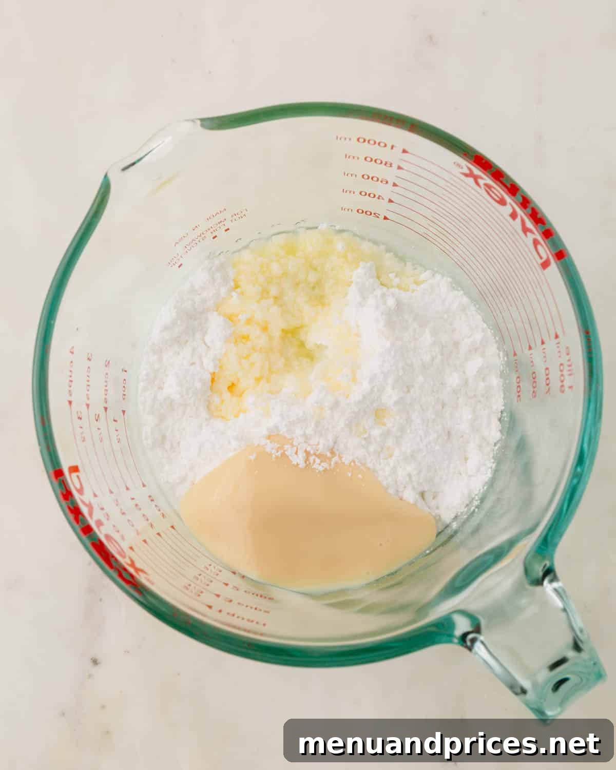 Minty Cocoa Macaron Bliss 17 Precisely measured powdered sugar, luscious sweetened condensed milk, and a hint of peppermint extract are gathered in a 4-cup measuring cup, ready to be transformed into the creamy mint candy filling.