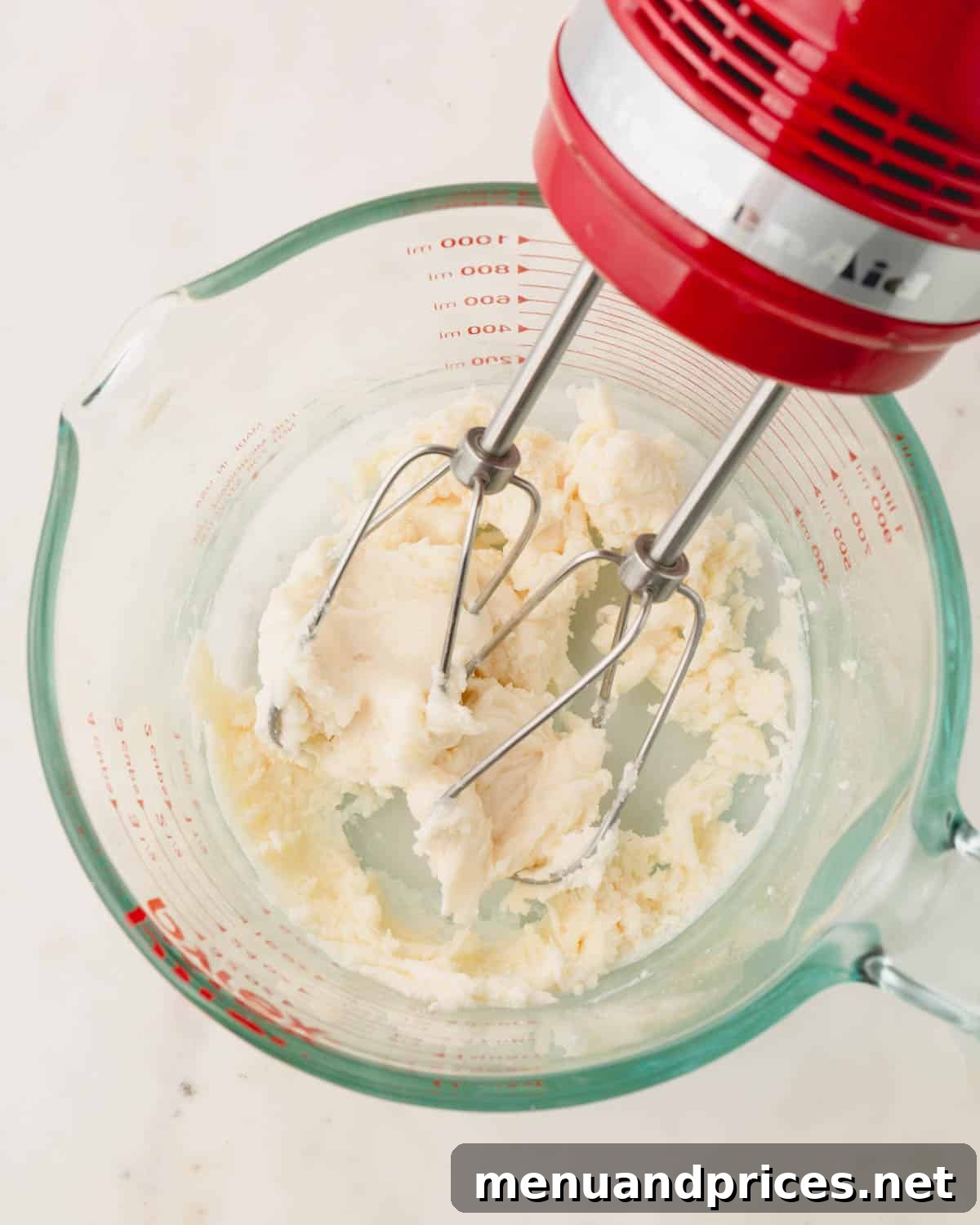 Minty Cocoa Macaron Bliss 18 The mint candy ingredients have been blended into a smooth, creamy paste using a handheld mixer, demonstrating the perfect consistency for the filling.