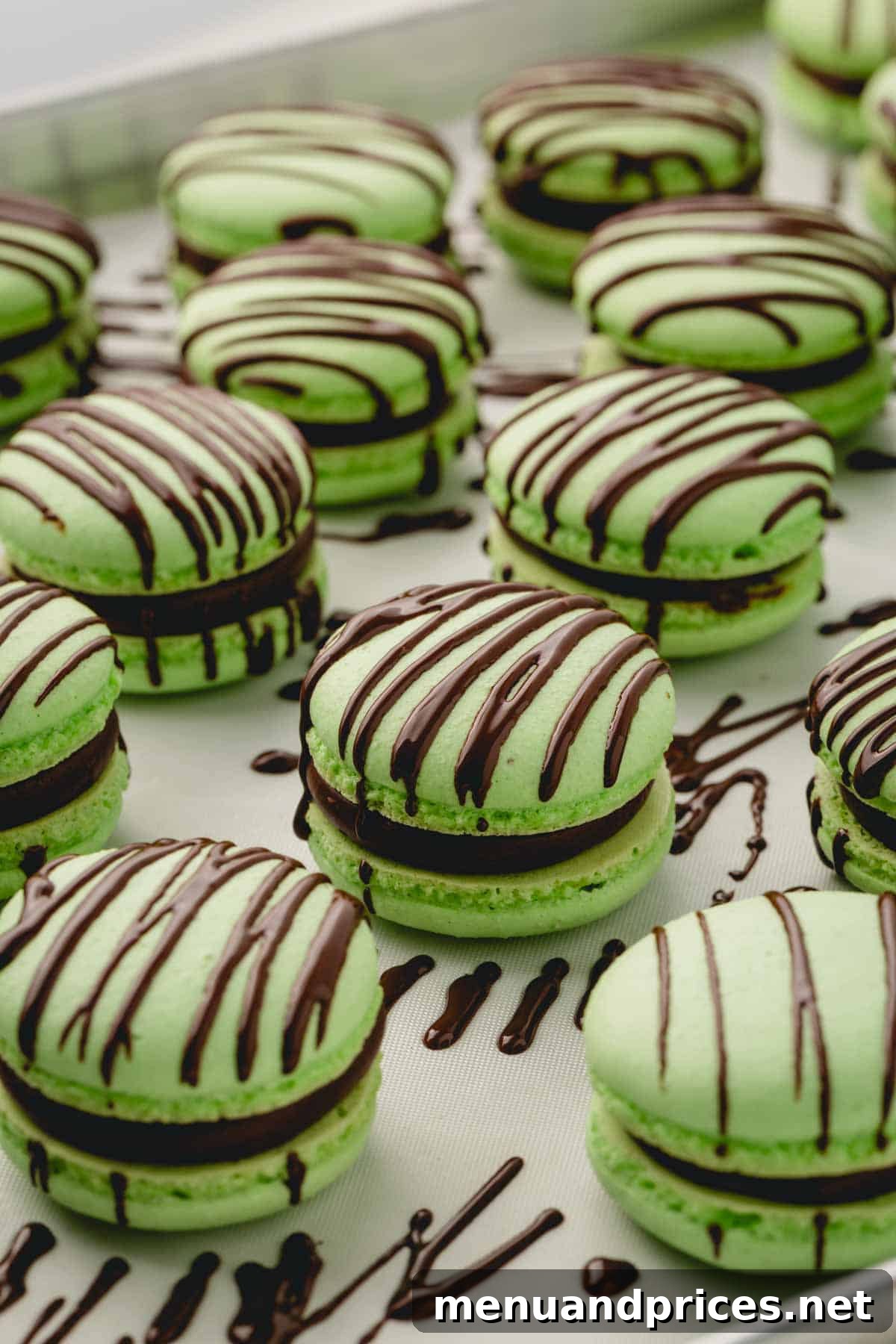 Minty Cocoa Macaron Bliss 22 A close-up of beautifully decorated mint chocolate macarons, featuring an elegant drizzle of melted chocolate over their vibrant green shells.